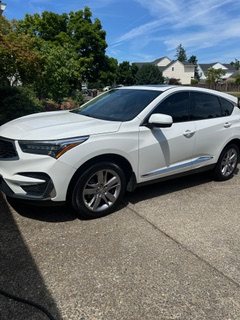 White SUV side view after detailing