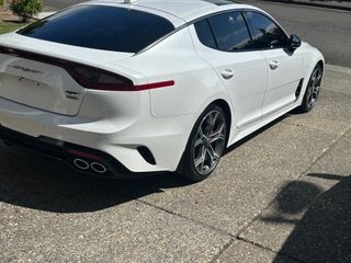 White sedan rear quarter after detailing
